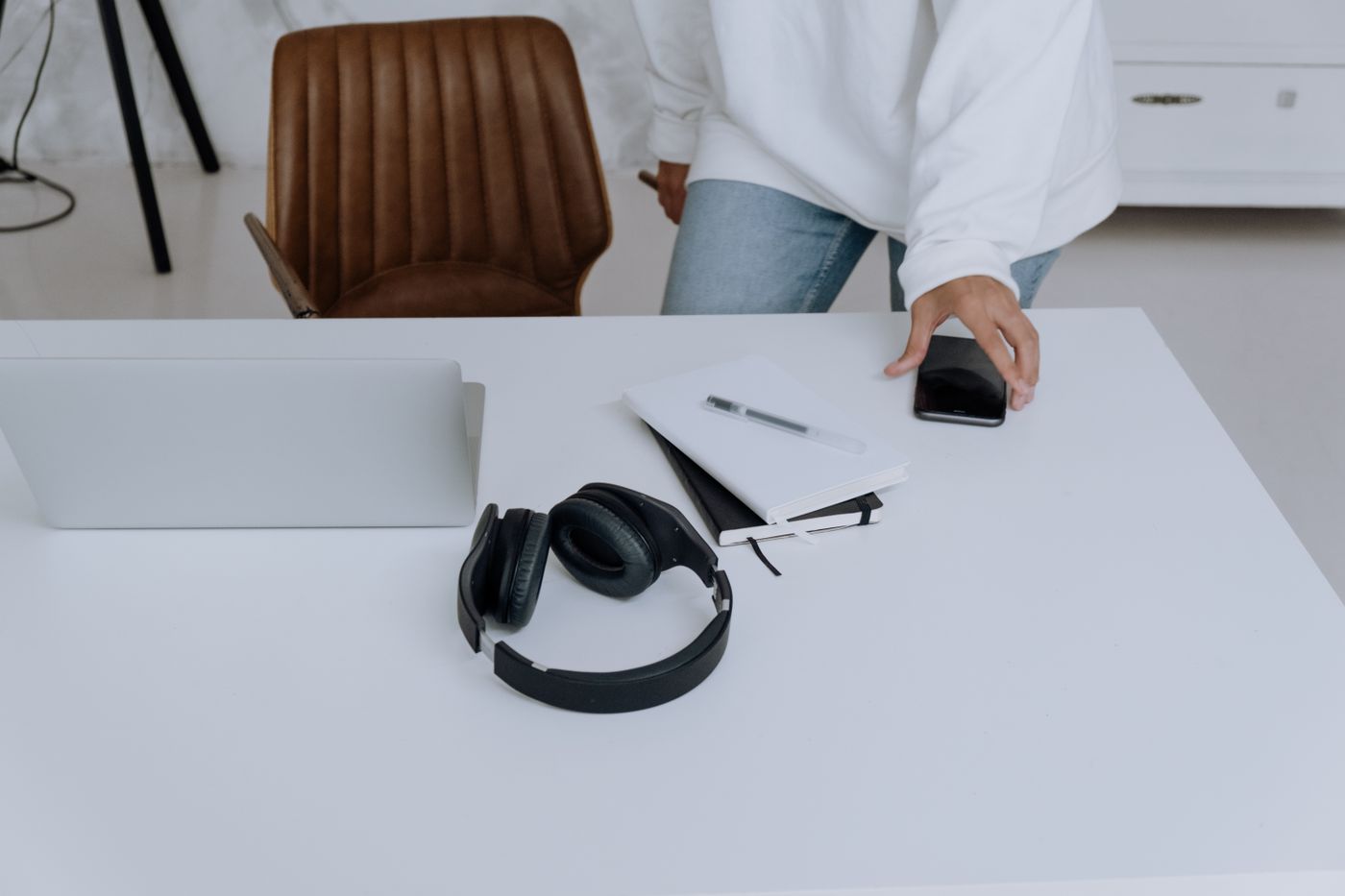 Laptop, headphones and notes on a desk